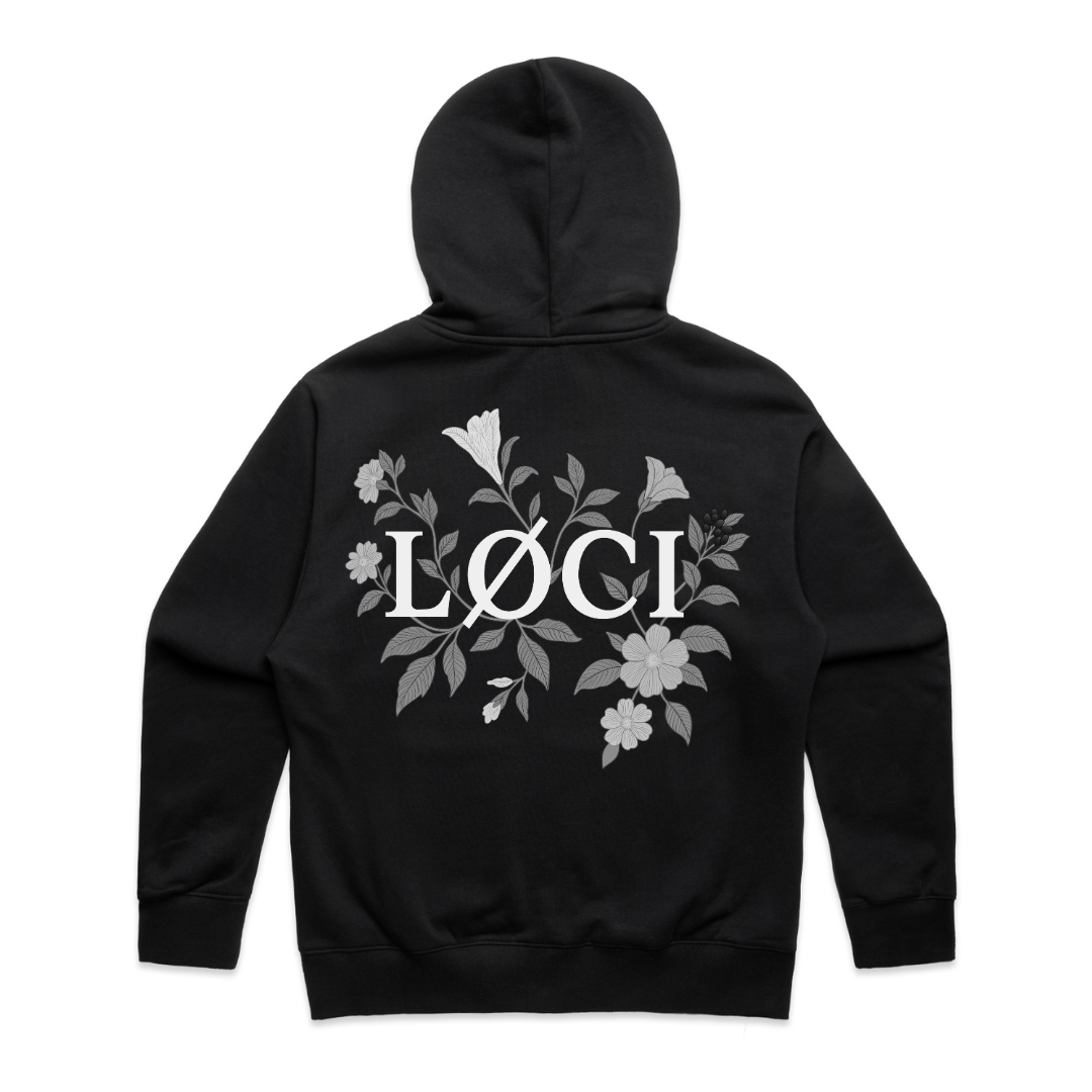 Black hoodie with floral design and 'Löci' logo on the back against a white background