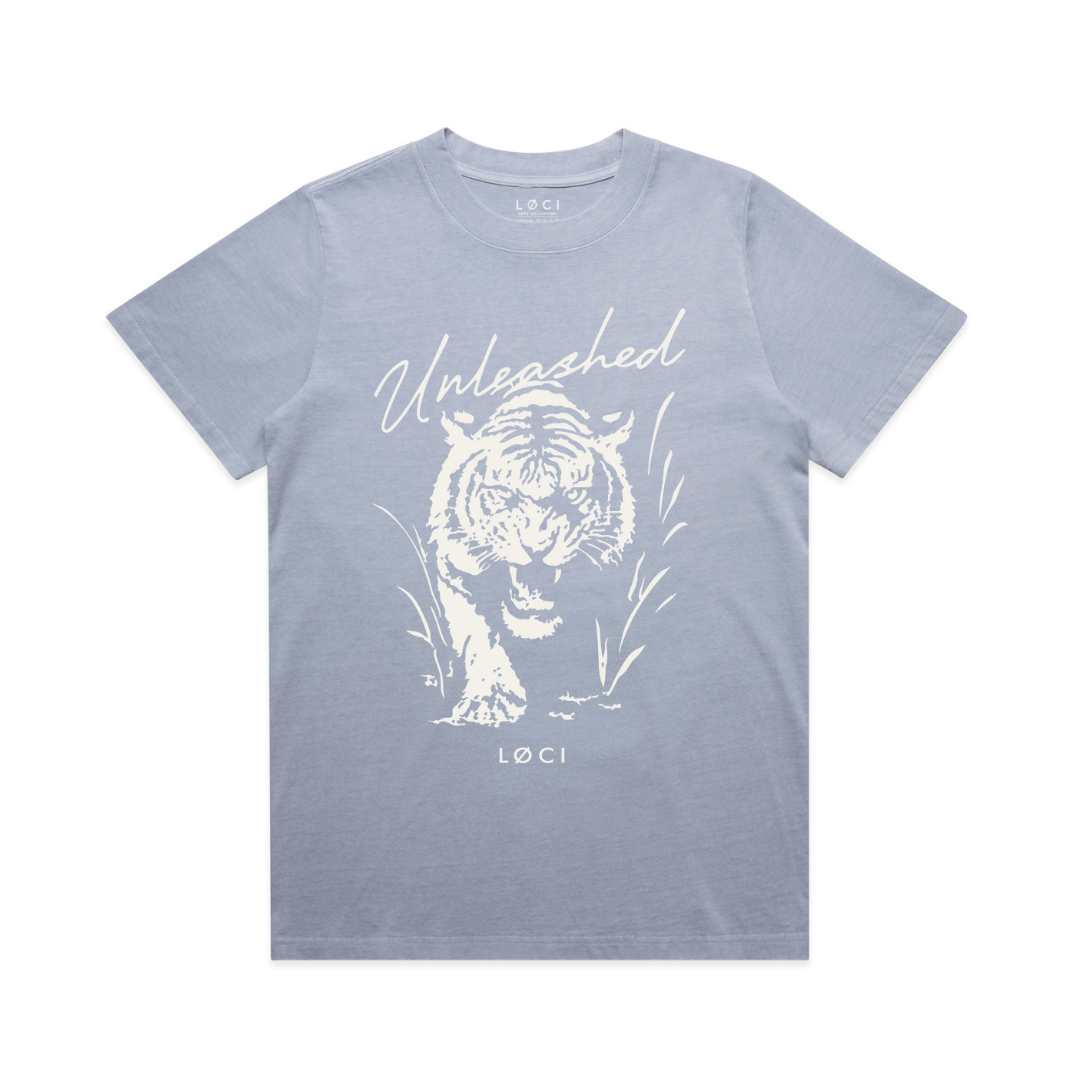 Light blue t-shirt with white tiger graphic and 'Unleashed' text on a white background