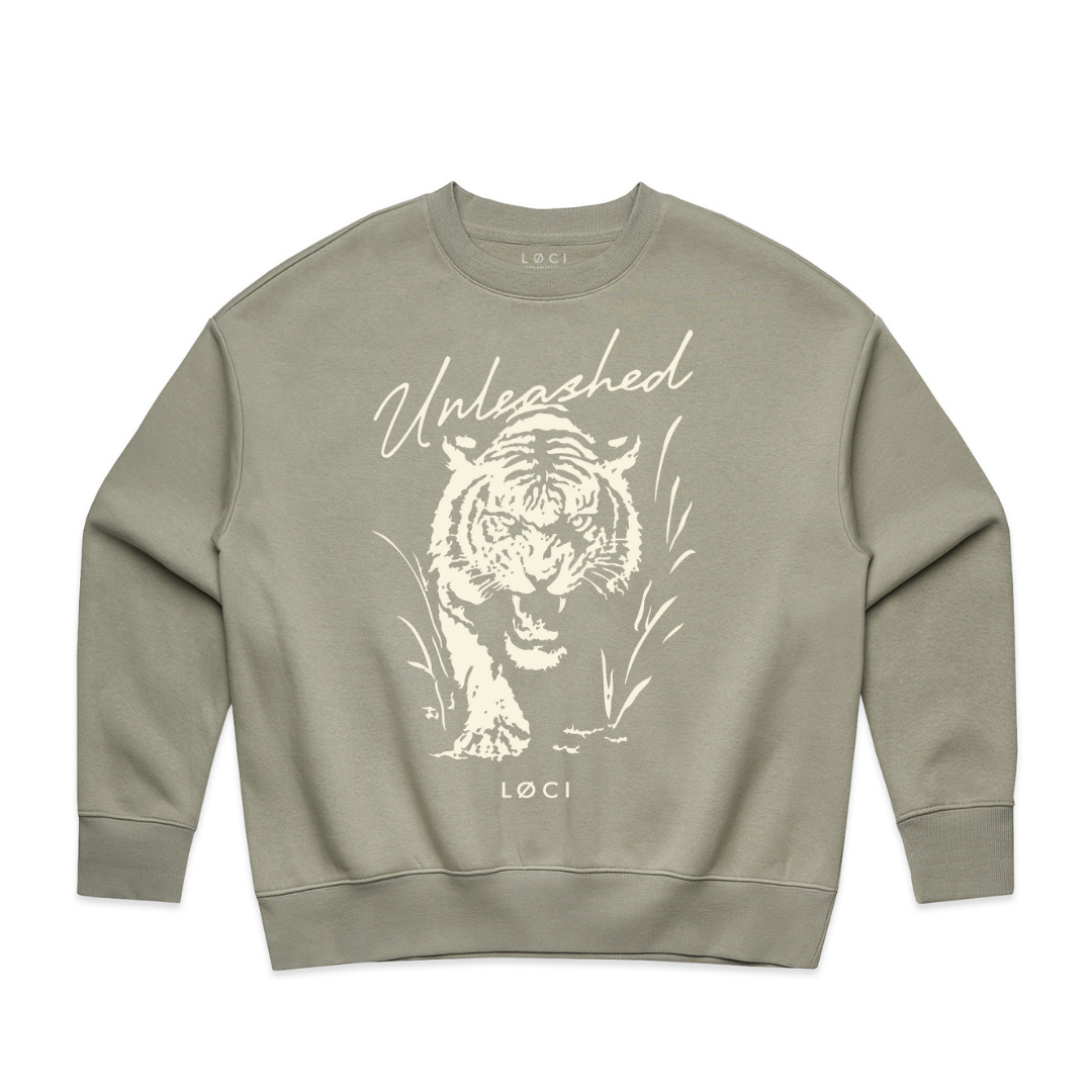 Sage green sweatshirt with a white tiger graphic and 'Unleashed' text on a white background