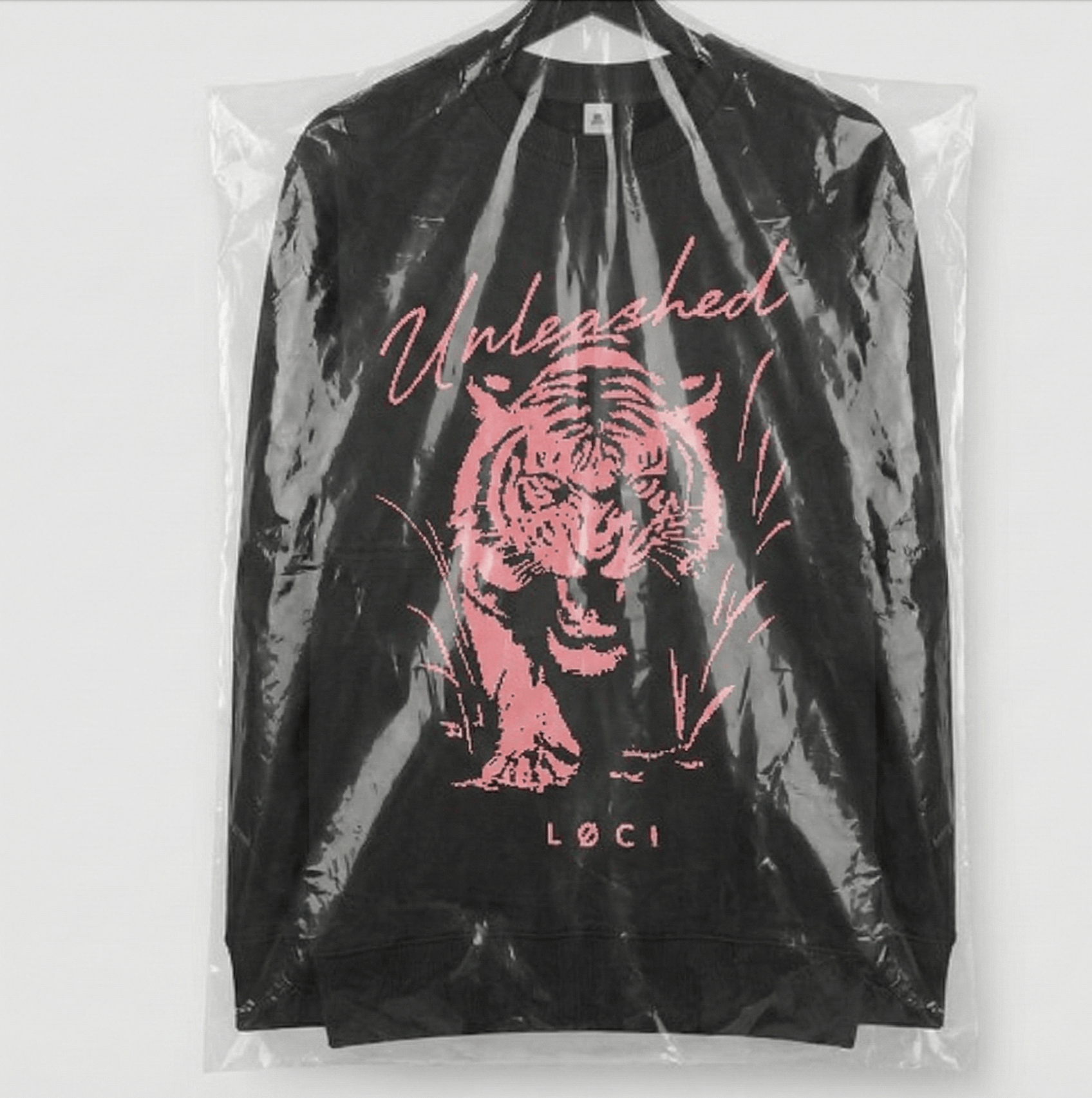 Black jacket with pink tiger design and 'Unleashed' text on a white background