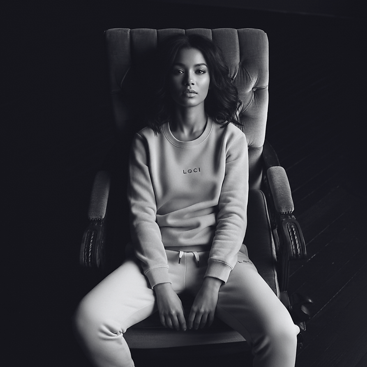 Seated model wearing a LØCI sweatshirt